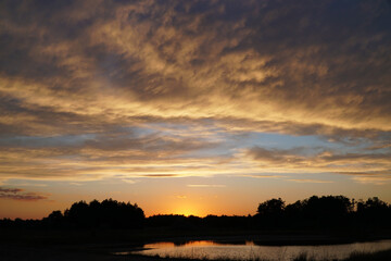 Fototapeta na wymiar Beautiful sunset sky on the river