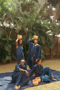 group of black eco fashion textile coworkers sitting in nature