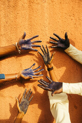 Vertical photograph of multicoloured hands