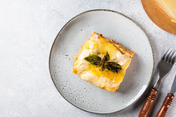 Piece of tasty hot lasagna. Traditional italian lasagna. Italian food. Close up lasagna. Bolognese sauce. Bechamel sauce. Still life of food. Homemade meat lasagna. Top view