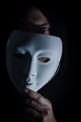Take off the mask - Portrait of a young hooded man who takes off his mask, letting his gaze be...