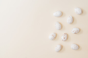 Flat lay easter composition with easter eggs on a beige background