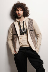 Fashion Model Posing, And  and Looking Confident In Studio, Standing against the wall