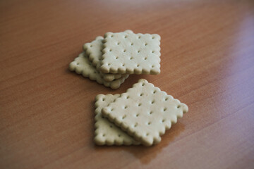 photo of biscuit crackers stacked in a slide on a wooden table two stacks
