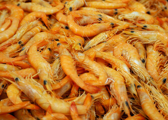 a lot of boiled orange-colored whole shrimp. side view.  seafood. omega-3