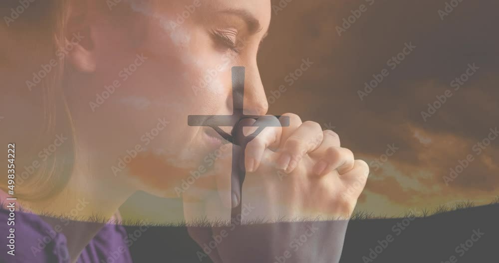 Poster Animation of caucasian woman praying and crucifix at sunset