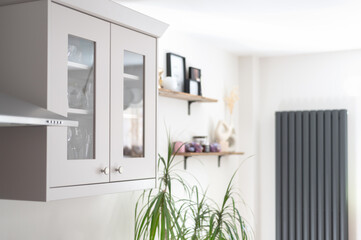 Modern new kitchen with light grey furniture and quartz worktop, light interior trendy units. Large...