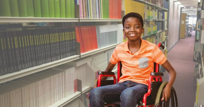 Animation of book week text over smiling african american schoolboy in wheelchair in library