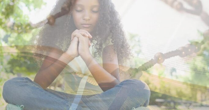 Animation of biracial girl praying and rosary with holy bible