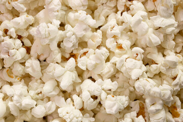 Scattered popcorn. Close-up picture of fluffy salted popcorn. background texture. View from above - Top view.