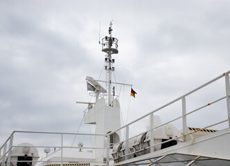 Ships antenna and navigation system in a cloudy sky. High quality photo