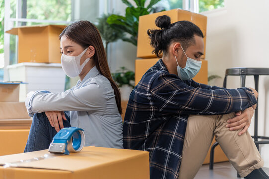 Young Asian Couple Feeling Sad And Upset Because Financial Problem Economic Crisis From Covid-19 Pandemic Effect Have To Move Out From Residence House. Business Bankruptcy Covid Pandemic Side Effect.