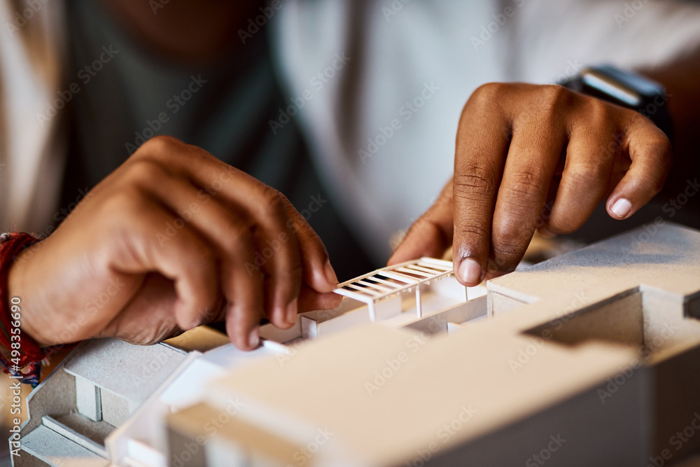 Poster Better designs for better living. Shot of an unrecognisable architect designing a building model in a modern office.