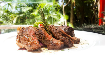 close up of a medium rare of meat cooking