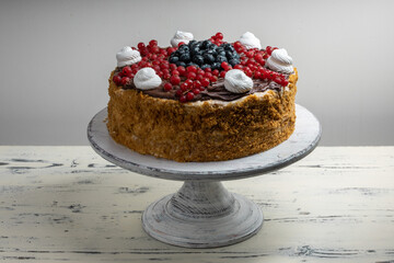 Multi-layered honey and cheesecake with fresh berries.