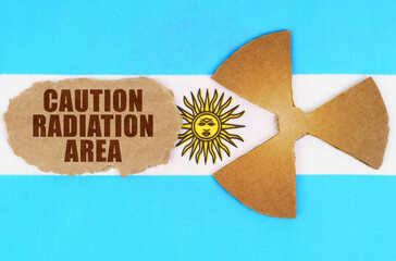 On the flag of Argentina, the symbol of radioactivity and torn cardboard with the inscription -...
