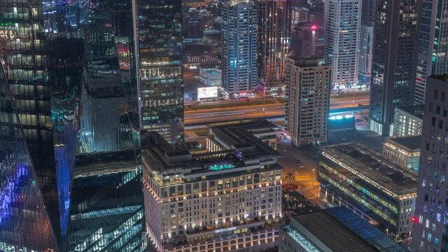 Skyscrapers near Sheikh Zayed Road and DIFC district night timelapse in Dubai, UAE.