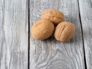 Walnut with shell on wooden background.