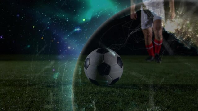 Animation of globe rotating over legs of caucasian male soccer player