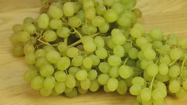 Hron grapes rotates on a wooden boards background	