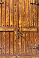 Old wooden church door with ornaments