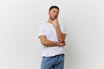 Pensive thoughtful young tanned handsome student man in basic t-shirt look aside posing isolated on over white studio background. Copy space Banner Mockup. People emotions Lifestyle concept