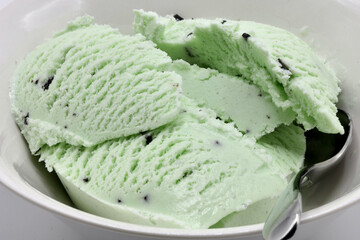Close-up view of freshly scooped mint ice-cream with chocolate chips.
