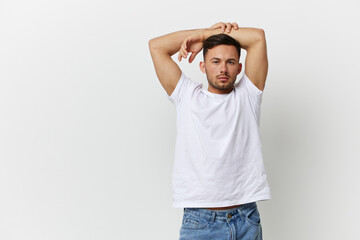 Young relaxed happy tanned handsome man in basic t-shirt folded hands overhead posing isolated on over white studio background. Copy space Banner Mockup. People emotions Lifestyle concept