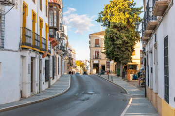 A traditional street of residential homes, shops and businesses in the Spanish Andalusian city of Ronda, Spain.	