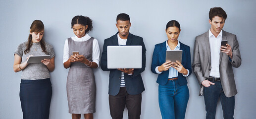 Standing in line. Cropped shot of a group of young businesspeople waiting in line for their...