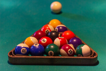 Snooker balls on a pool table in a billiard room for american billiard game.	