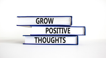 Grow positive thoughts symbol. Concept words Grow positive thoughts on books. Beautiful white table white background. Business grow positive thoughts concept. Copy space.