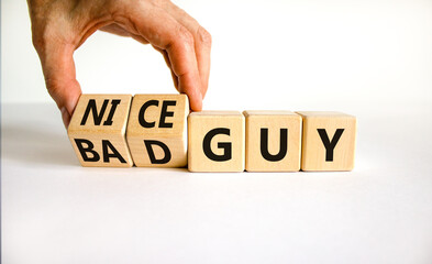 Nice or bad guy symbol. Businessman turns cubes and changes concept words Bad guy to Nice guy....