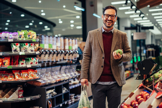 Handsome man shopping groceries in the supermarket
