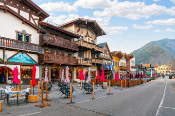 The main street through the Bavarian themed village of Leavenworth with outdoor sidewalk cafes lining up in the late Autumn in Eastern Washington State, USA. - obrazy, fototapety, plakaty