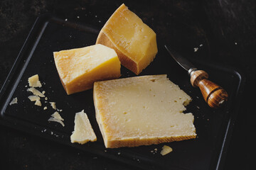 Parmesan cheese on wooden board - obrazy, fototapety, plakaty