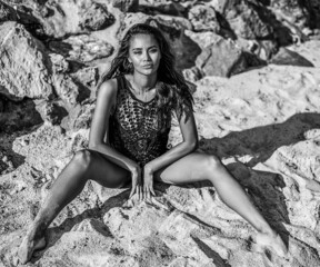Black and White portrait of chic female model posing at the beach - 498365242