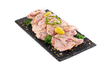 Сhicken wings in marinade on a black plate