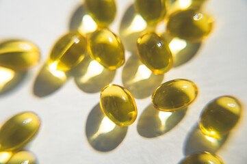 Close-up of yellow capsules. Health care. Useful food additives. Vitamin D. Fish oil.