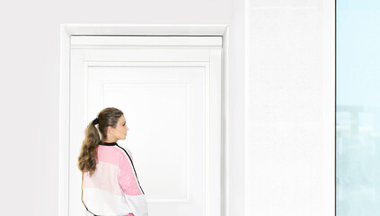 Beautiful woman opening the door of her home.