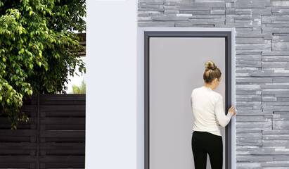 Fototapeta premium Beautiful woman opening the door of her home.