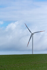 Fototapeta na wymiar Single windmill turbine on green field