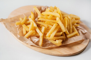 french fries on a wooden plate