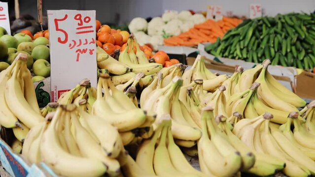 View of bananas, apples, and other fruits in the market. Stickers with price. Tel Aviv, Israel