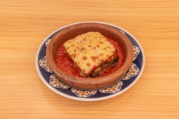 parmigiana, is a typical dish from Sicily and southern Italy. It is like a lasagna made from aubergines, with grated cheese, tomato sauce and basil leaves.