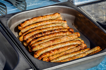 Grilling sausages on barbecue grill.