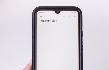 Hand smartphone and inspirational quote on screen with camera, copy space for text or design. Concept of motivation phrases. White background.