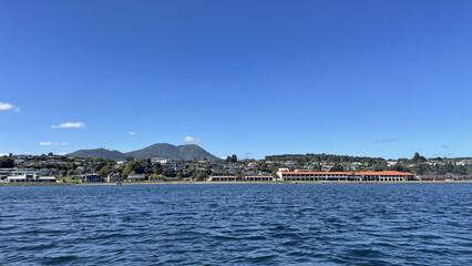 Naklejka premium Lake Taupo New Zealand taken from the lake looking towards Mt Tauhara and the hotels on the Lake Front