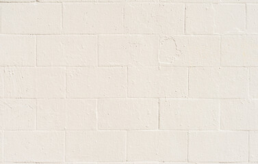 Painted brick wall close-up, light cream color, background