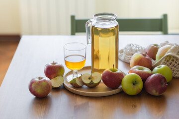 Fresh homemade organic apple juice or cider on a wooden table in a glass jug